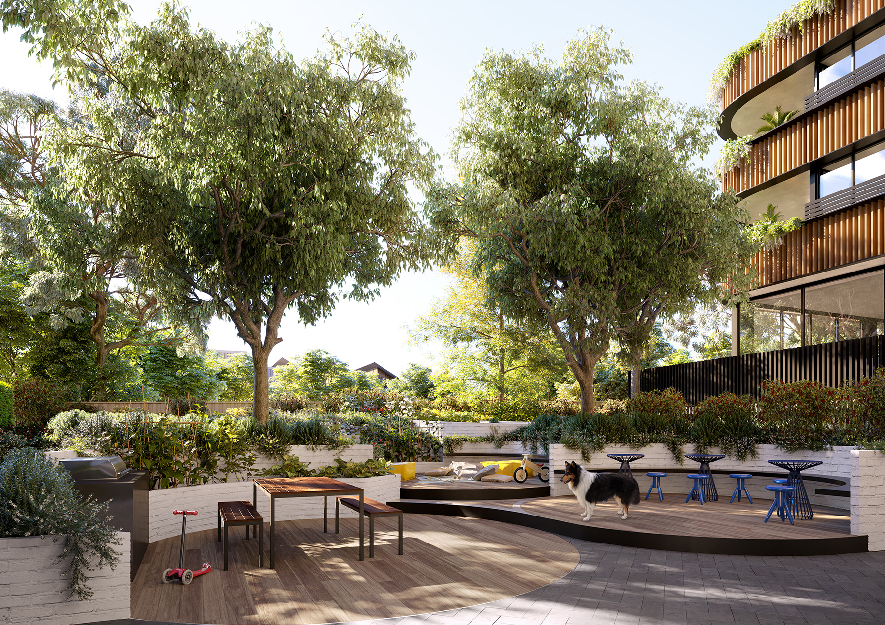 Sunlit communal courtyard with large shade trees, terraced planter beds and wooden seating; a collie near children's toys and low tables, framed by a modern apartment building with curved balconies and cascading greenery.