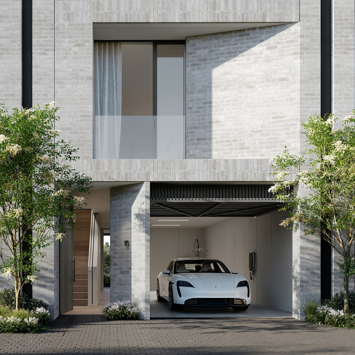 Modern minimalist townhouse facade with open garage revealing a white electric sports car plugged into a wall charger, a glass-front balcony above, pale brick cladding and trees framing the entrance to convey upscale urban living.