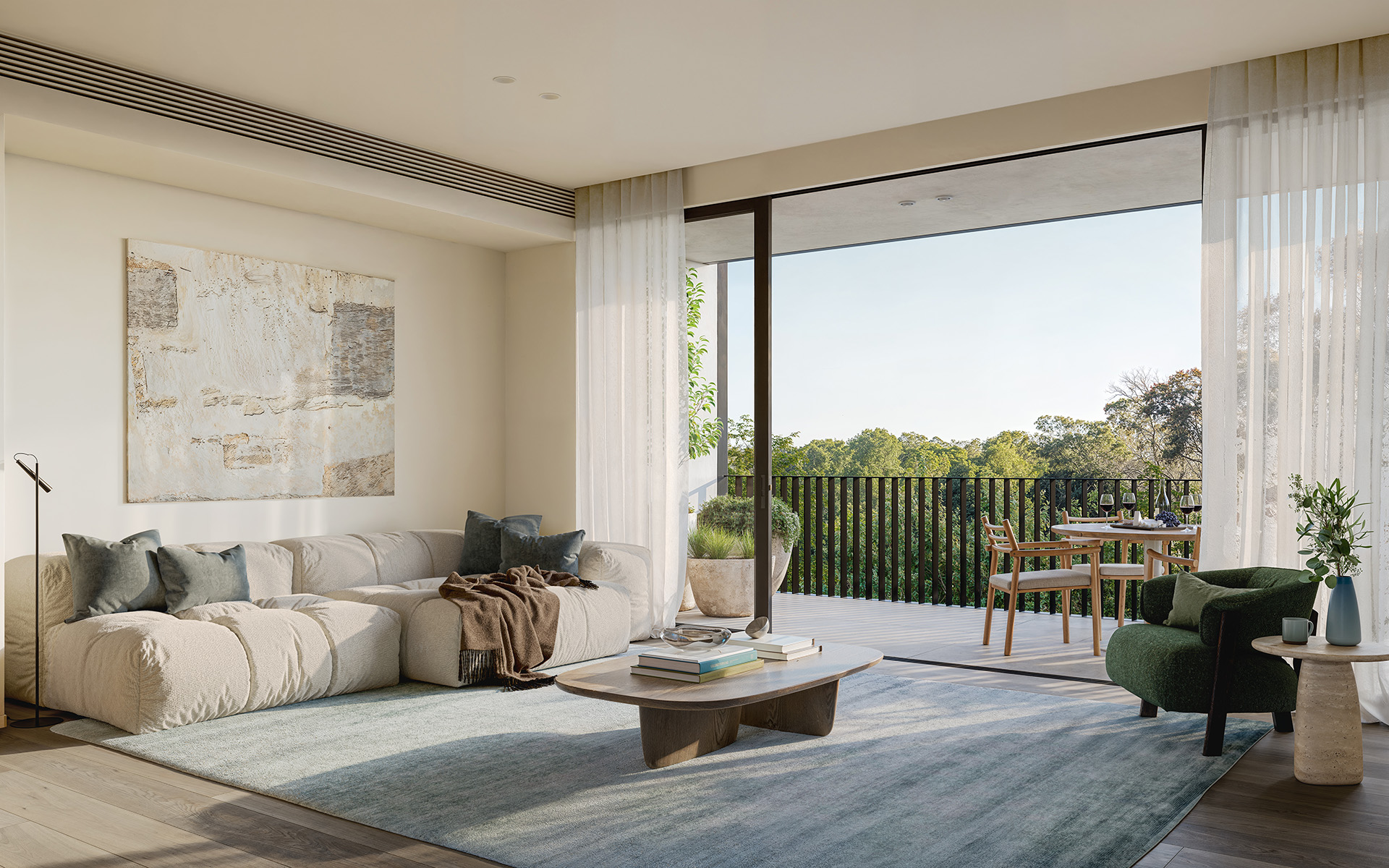 Sunlit modern living room with a low cream sofa, soft rugs and armchair opening through floor-to-ceiling sliding glass doors to a balcony dining set and tree-lined view, conveying a calm indoor–outdoor lounge for relaxing and casual dining.