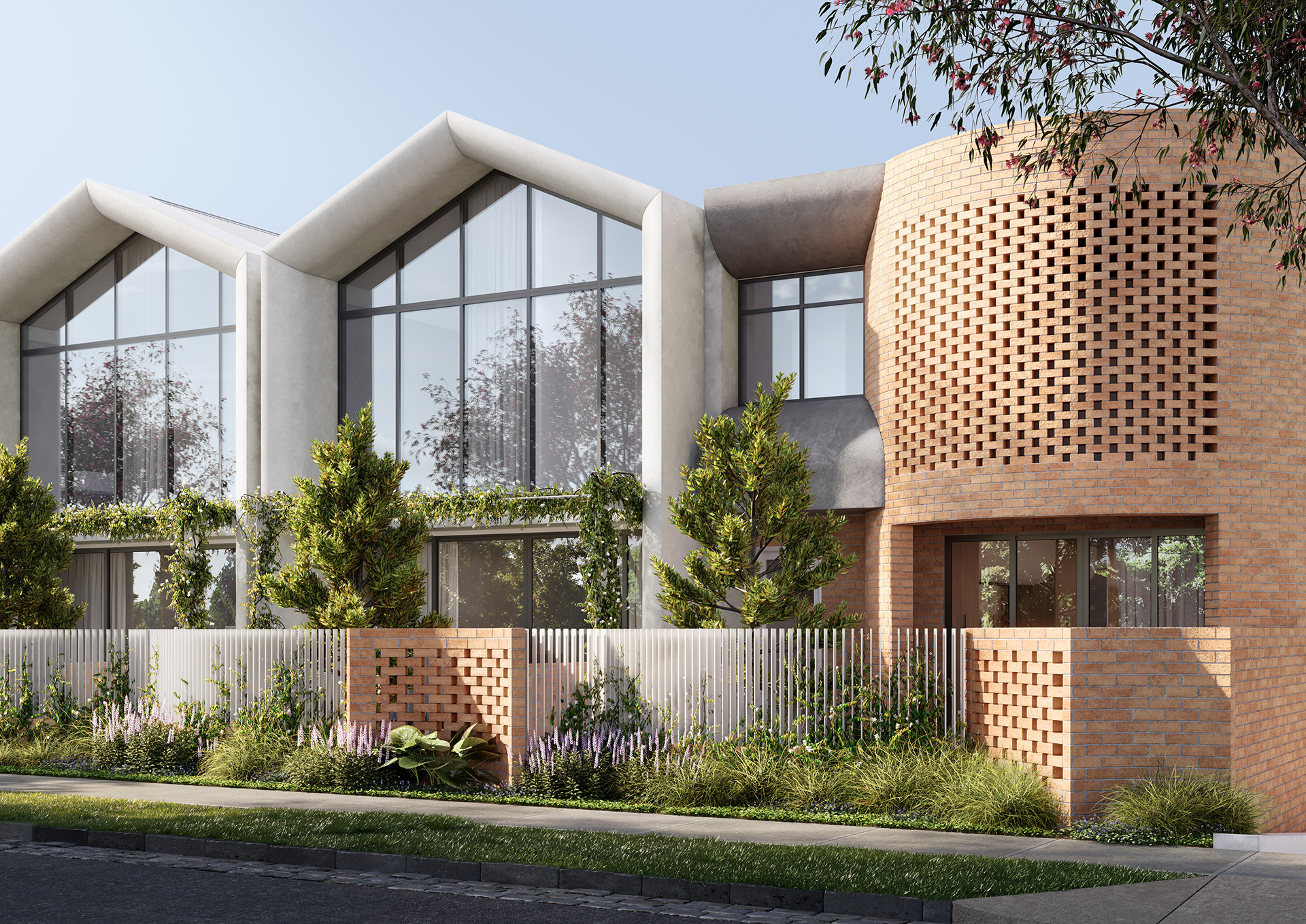 Contemporary residence featuring three peaked concrete roof sections and expansive floor-to-ceiling glazing beside a rounded perforated brick wall, framed by climbing vines, ornamental trees and a landscaped verge creating a private modern street-facing façade.