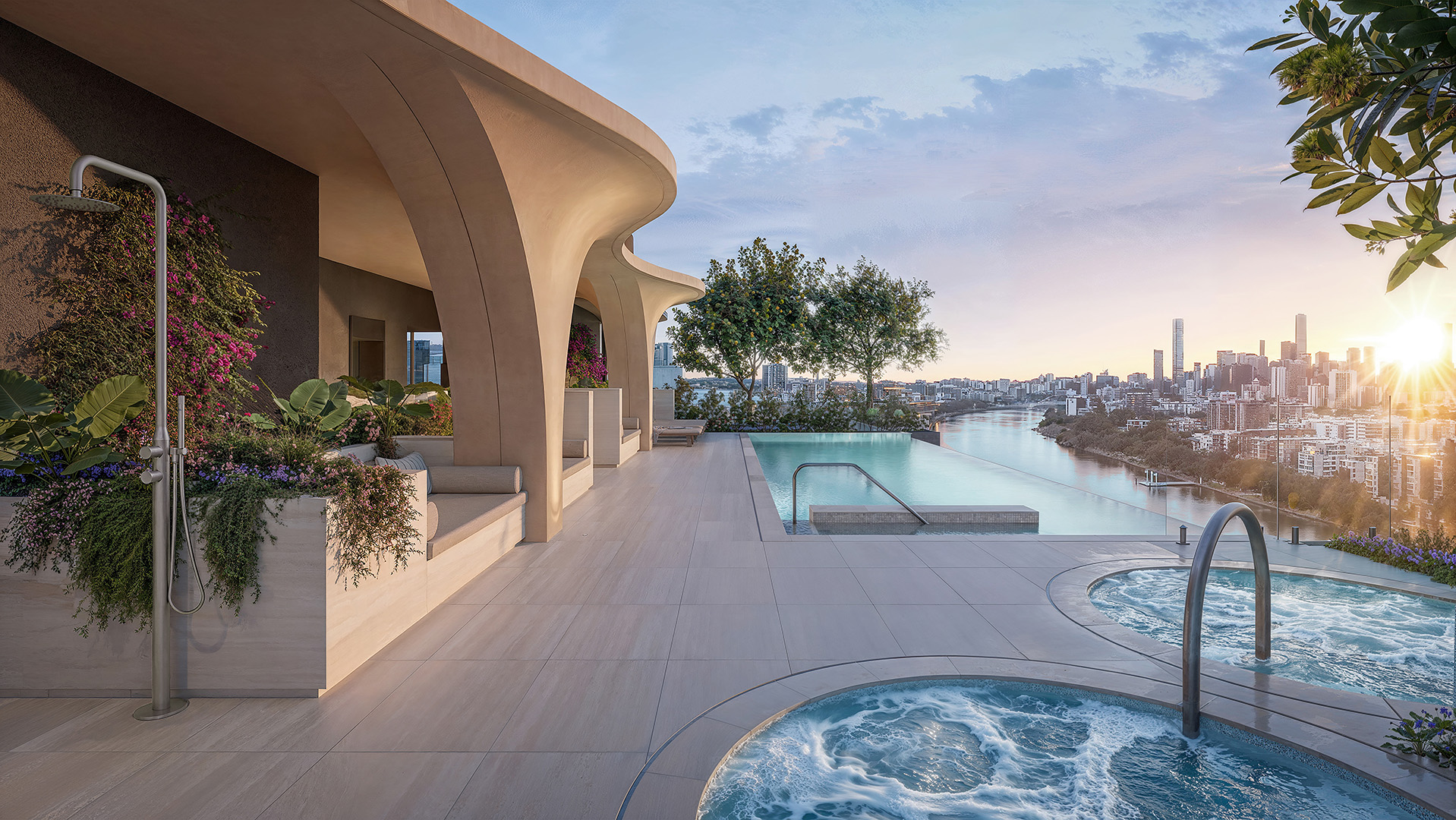 Rooftop wellness terrace with an infinity pool and bubbling hot tubs, sculpted arching columns, planted seating alcoves and an outdoor shower, overlooking a river and city skyline at sunset.
